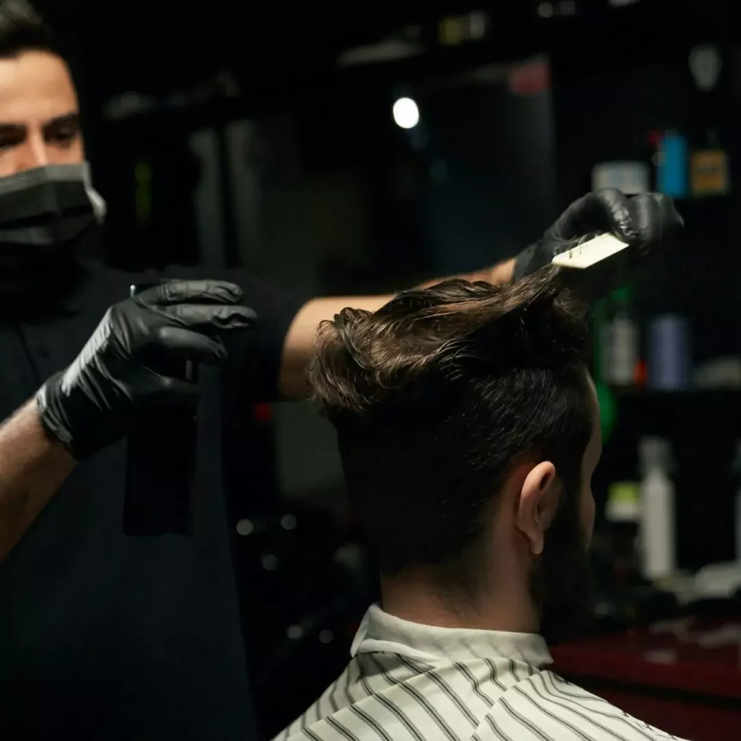 male-professional-barber-doing-hair-styling-to-handsome-guy male-professional-barber-doing-hair-styling-to-handsome-guy